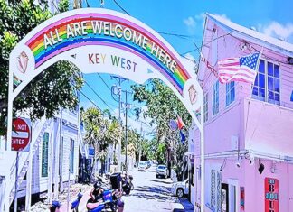 a painting of a city street with a rainbow arch