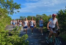 COUNTDOWN TO DISTRICTS UNDERWAY FOR KEYS CROSS COUNTRY RUNNERS a group of people riding bikes down a road