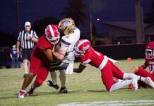 LAST MEN STANDING: KEY WEST FOOTBALL CONTINUES POSTSEASON PUSH a group of football players playing a game of football
