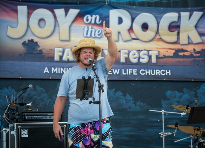 a man standing on a stage with a microphone