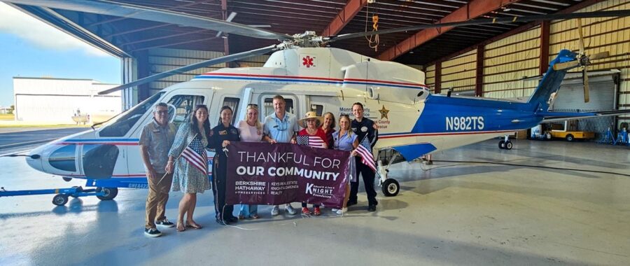 a woman lifting a barbell in a gym