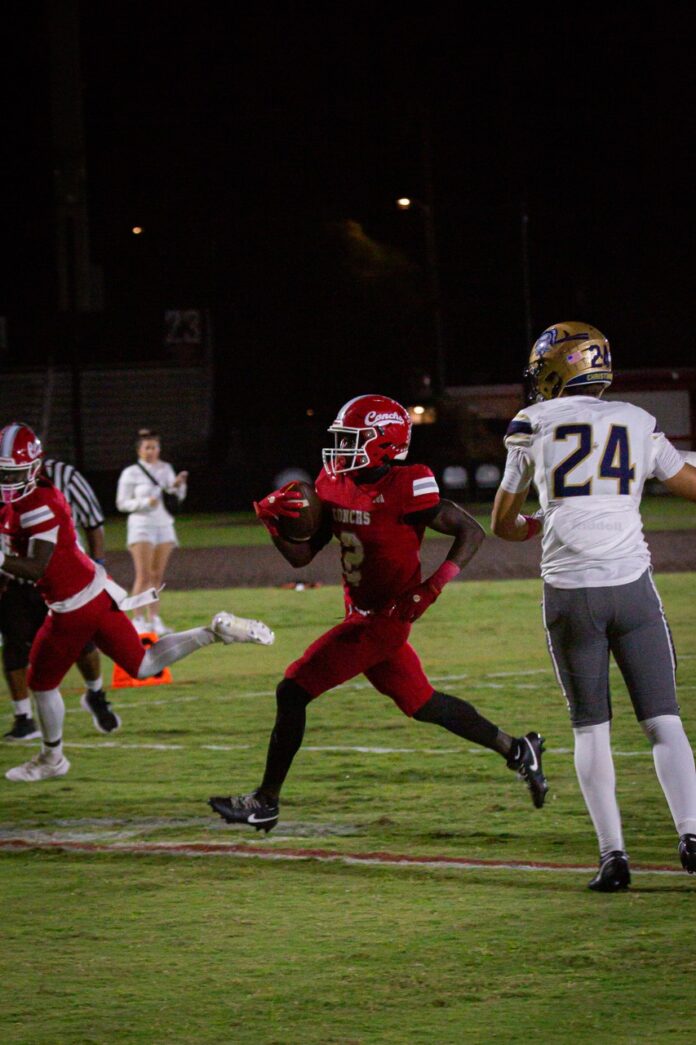 a football player running with the ball during a game
