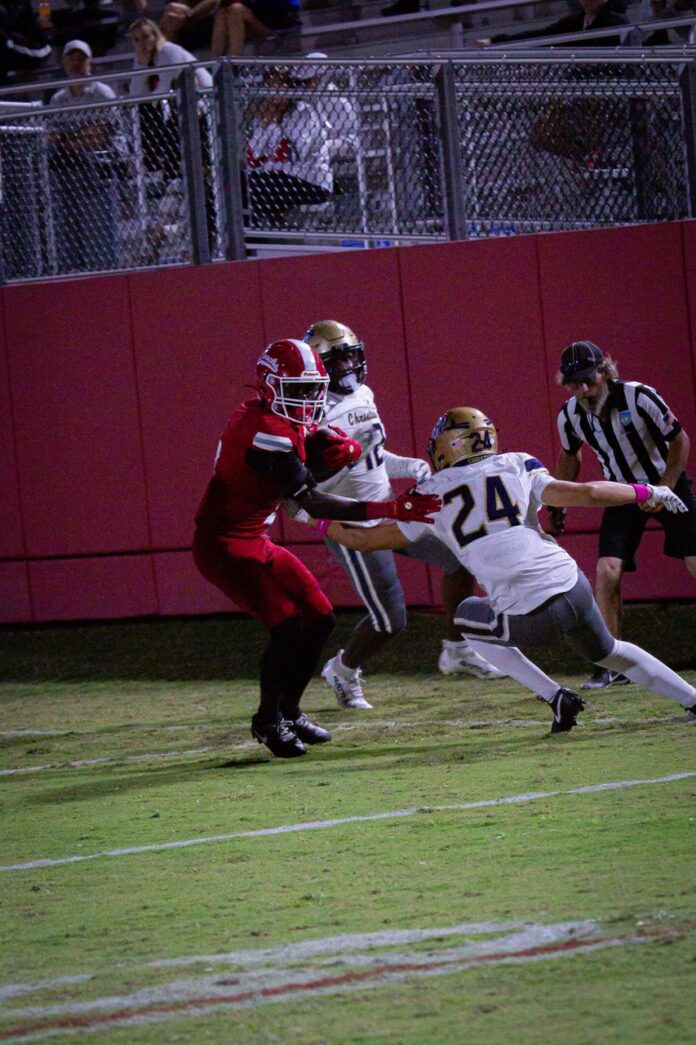 a football player running with the ball during a game