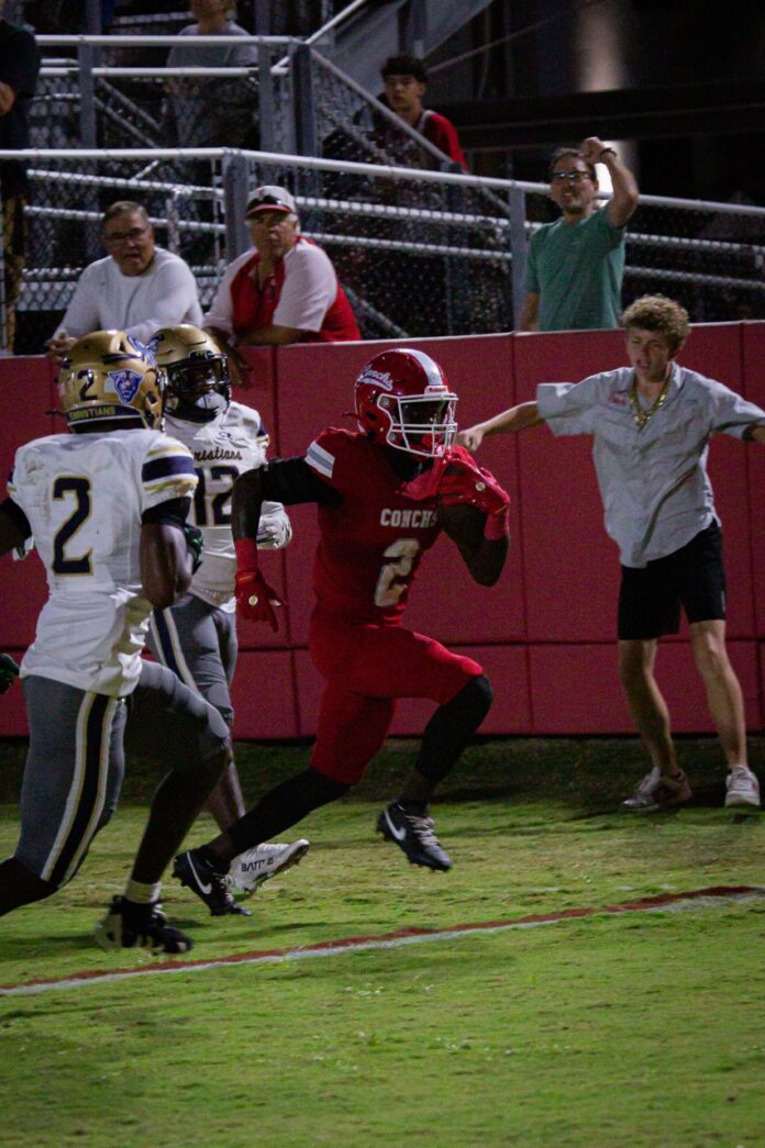 a football player running with the ball during a game