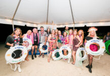 TOMORROWLAND-THEMED BIG KAHUNA FUNDRAISER SUPPORTS COMMUNITY HEALTH a group of people standing under a tent