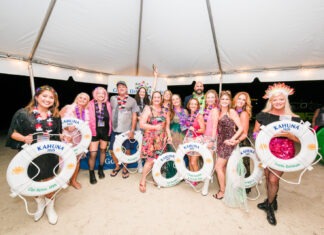a group of people standing under a tent