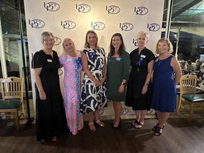 a group of women standing next to each other