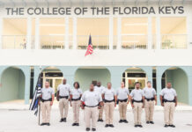 a group of men standing in front of a building