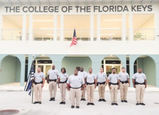 a group of men standing in front of a building