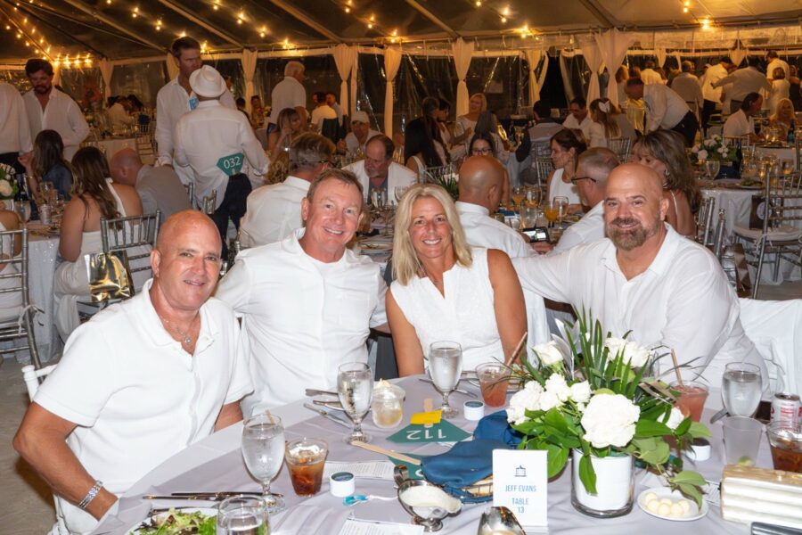 a group of people sitting at a table in a tent
