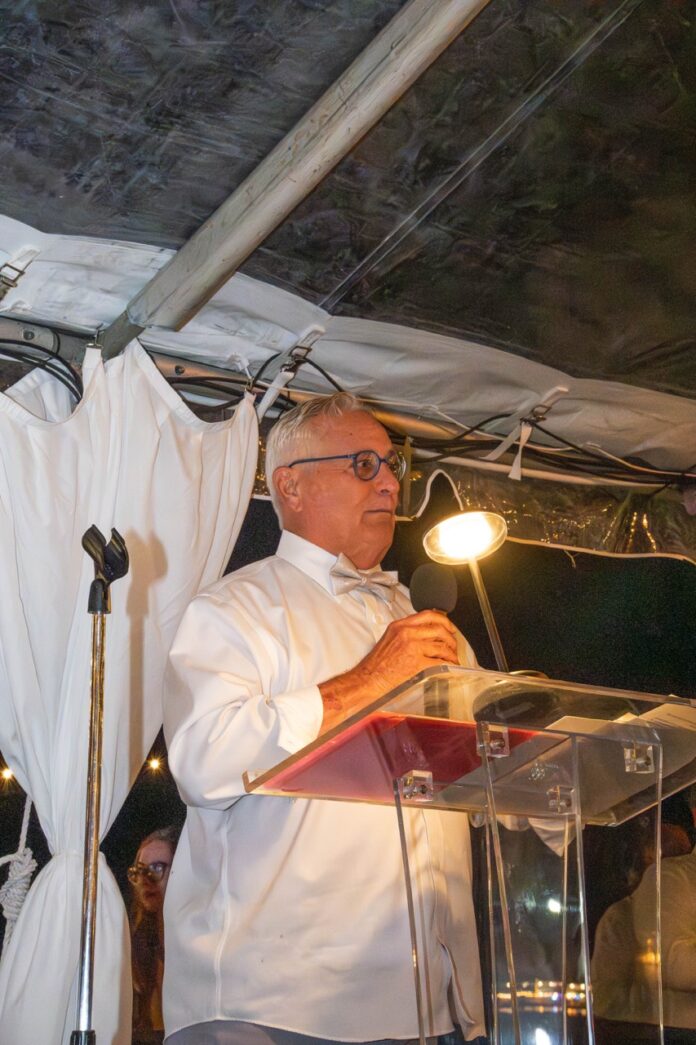 a man standing at a podium in front of a microphone