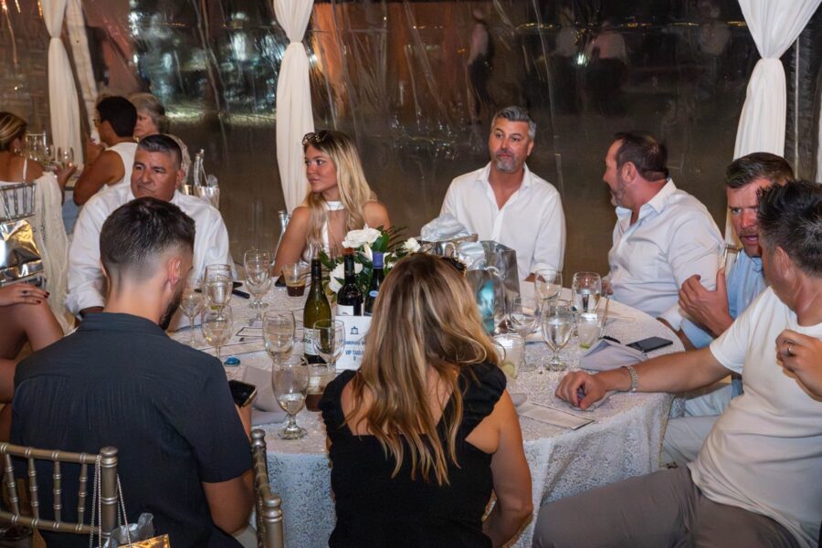 a group of people sitting around a dinner table