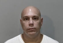 a man with a bald head and a white shirt