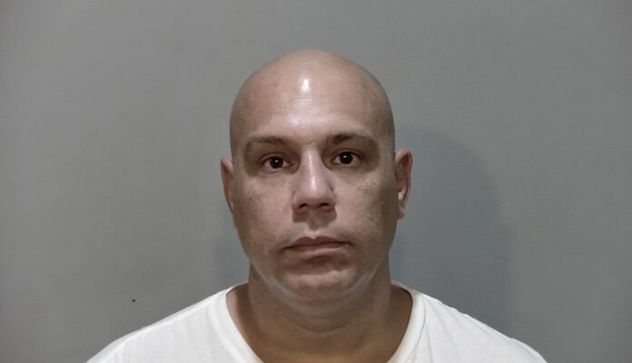 a man with a bald head and a white shirt