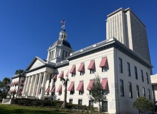 FLORIDA KEYS MUNICIPALITIES EXPRESS CONCERNS OVER PROPERTY TAX PROPOSALS IN TALLAHASSEE a large building with a flag on top of it