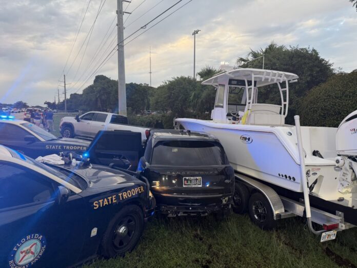 a police car and a boat on the side of the road