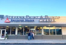 two people standing outside of a building