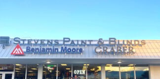 two people standing outside of a building