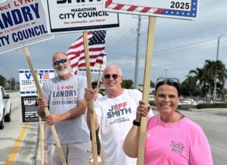 STRUYF, STILL & LANDRY EARN COUNCIL SEATS IN 2025 MARATHON ELECTION a group of people holding signs on the side of a road