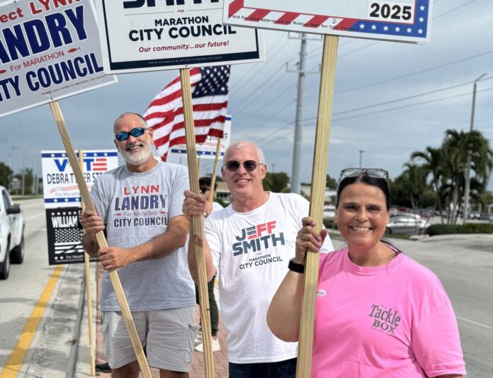 a group of people holding signs on the side of a road