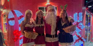 a group of people dressed as santa clause posing for a photo