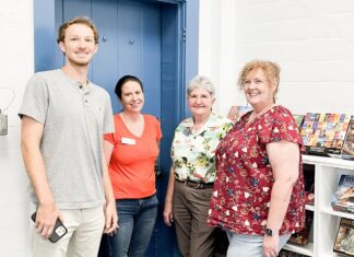 a group of people standing in front of a blue door
