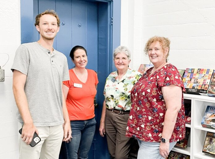 Islamorada library staff Large a group of people standing in front of a blue door
