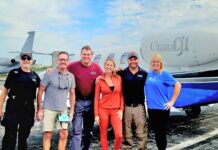 KEYS WEEKLY JOINS DISASTER RELIEF MISSION TO JAMAICA a group of people standing in front of an airplane
