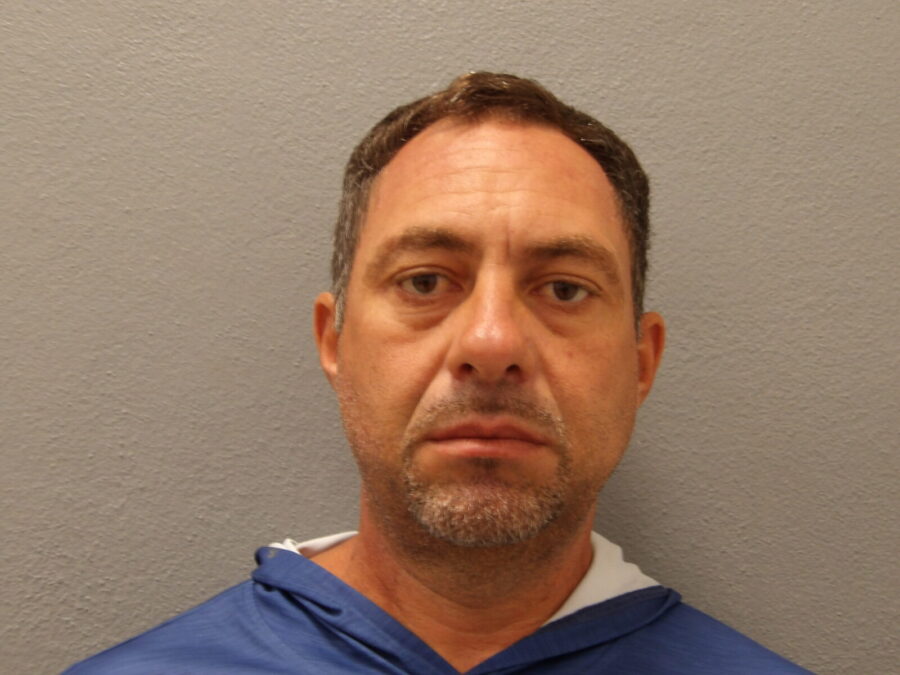 a man in a blue hoodie looking at the camera