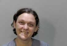 a woman is smiling and posing for a picture