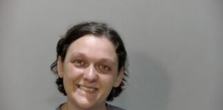 a woman is smiling and posing for a picture