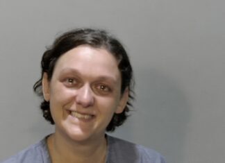 a woman is smiling and posing for a picture