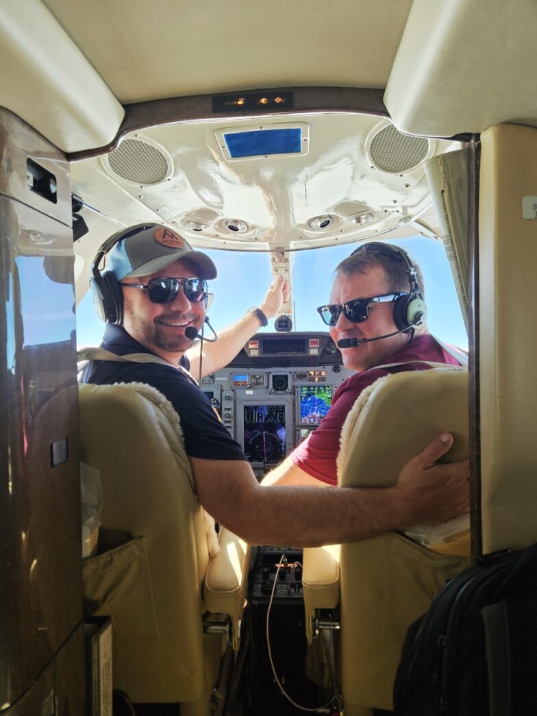a couple of men sitting in the cockpit of a plane