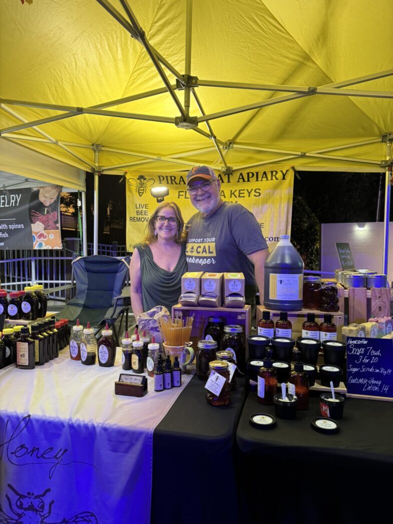 a man and a woman standing under a tent