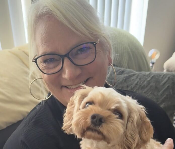 Kristi Ferrise a woman holding a small dog in her arms