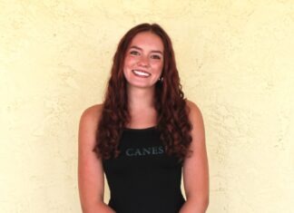 ATHLETE OF THE WEEK: LAYNE SMITH a woman standing in front of a yellow wall