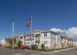 a row of houses with a flag flying in the background