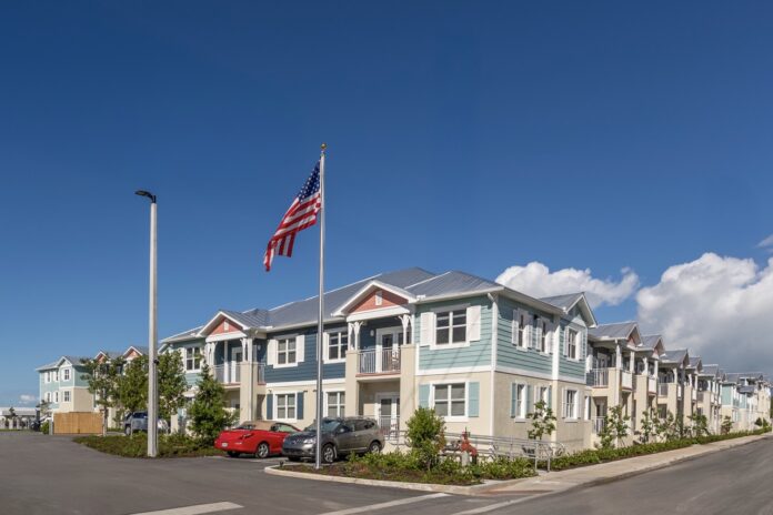 Lofts of Bahama Village--3 Large a row of houses with a flag flying in the background