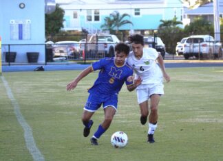 a couple of young men playing a game of soccer
