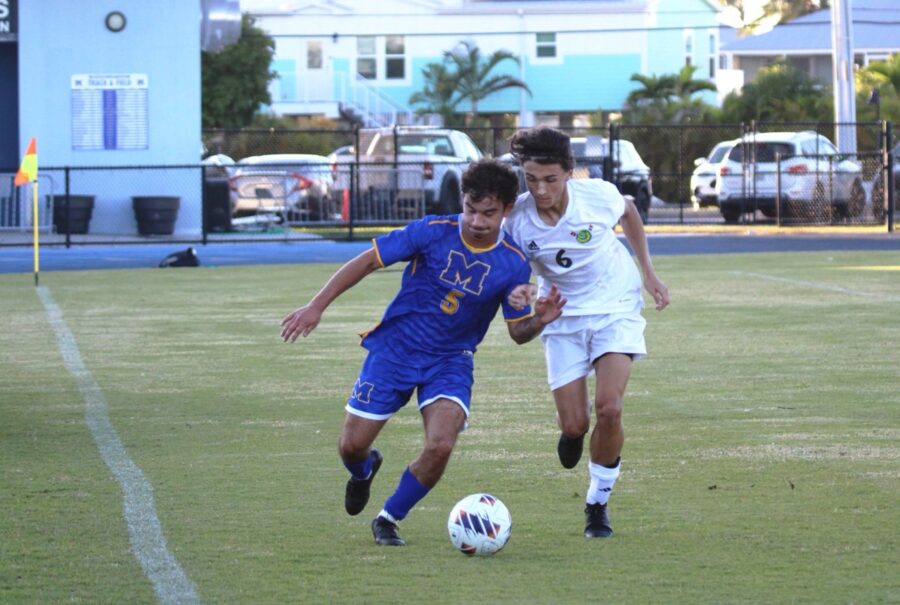 a couple of young men playing a game of soccer