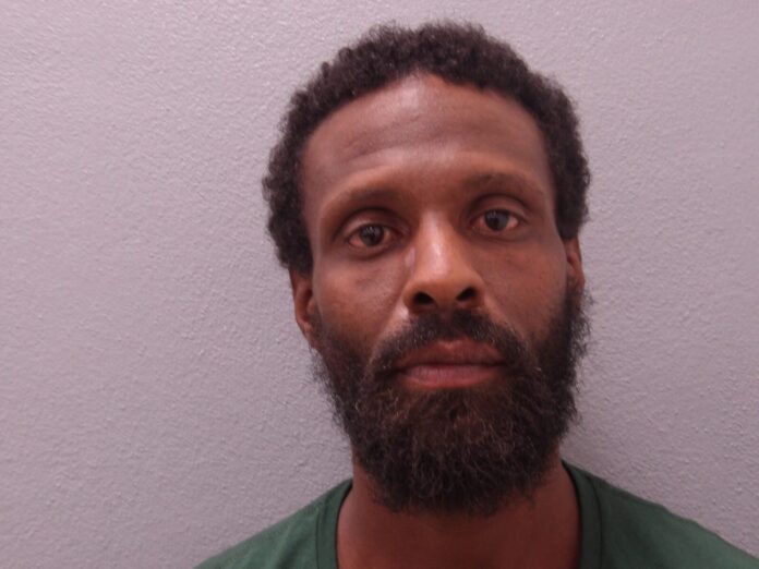 a man with a beard and a green shirt