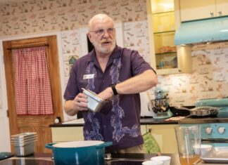 a man standing in a kitchen preparing food