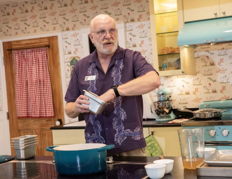 a man standing in a kitchen preparing food