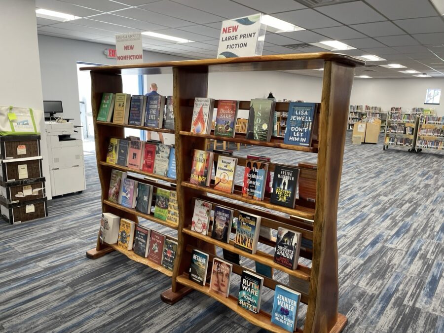 a library filled with lots of books on top of wooden shelves