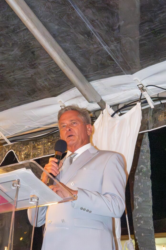 a man in a suit speaking into a microphone