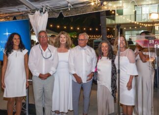 NIGHT IN WHITE GALA SUPPORTS ALLIGATOR REEF LIGHTHOUSE RESTORATION a group of people standing next to each other