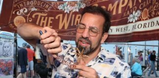 a man holding a piece of food in his hand