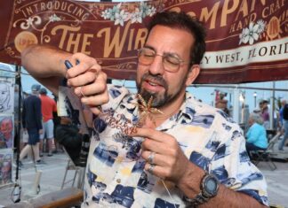 a man holding a piece of food in his hand