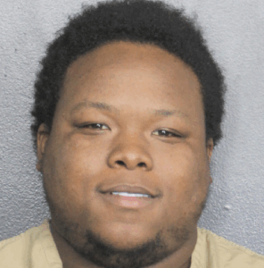 a man in a tan shirt is looking at the camera