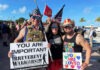 IRREVERENT WARRIORS USE HUMOR TO STEM SUICIDE IN VETERANS a group of people standing next to each other holding signs